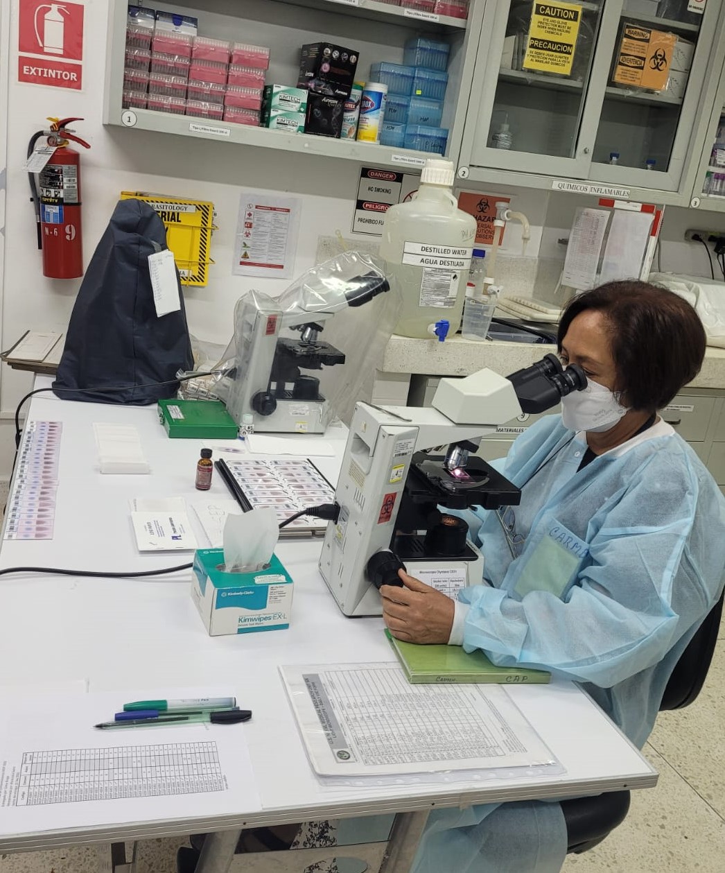 NAMRU-6 staff pose for a photo while performing malaria microscopy in the NAMRU-6 Iquitos laboratory. (U.S. Navy photo by Greys Braga/Released)